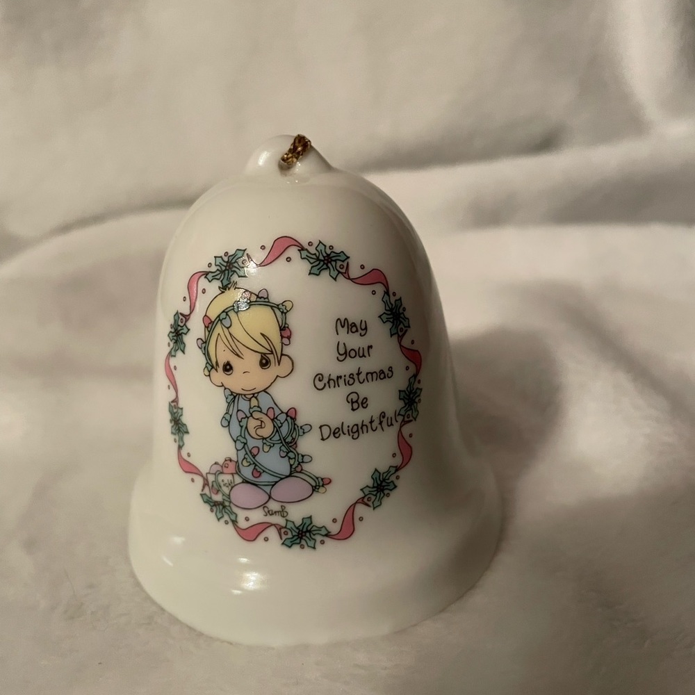 Precious Moments Bell reads “May Your Christmas Be Delightful “.